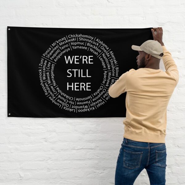 We're Still Here Black Wall Flag by Wayuką́